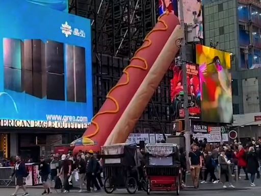 Why is there a giant hot dog art installation in Times Square?