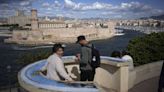 A ship carrying the Olympic torch arrives in Marseille amid fanfare and high security