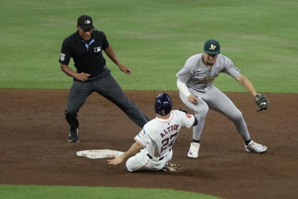 Bunt-fueled 12th-inning rally lifts A's over Astros