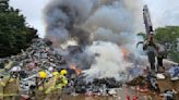 More than 40 firefighters tackling scrap metal fire next to railway | ITV News