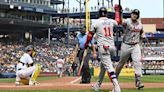 ...high-fives with Orlando Arcia after hitting a solo home run in the eighth inning against the Pittsburgh Pirates at PNC Park on Sunday, May 26, 2024, in Pittsburgh.