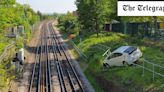 Pictured: Car teeters on the edge of Tube tracks