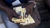 Battered Zimbabwe Currency Falls Past 20,000 Per Dollar in Official Trade