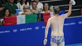 Pool worker strips to his briefs to retrieve a lost swim cap, drawing whistles from fans