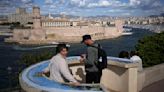 The Olympic torch is being welcomed in French port city of Marseille with fanfare and high security