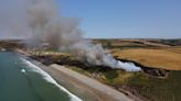 Drone photos show huge gorse fire at Welsh beach as UK temperatures soar