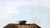 An Israeli tank stationed atop a sand mound near the border with the Gaza Strip