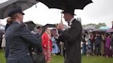 William braves wet conditions to host Buckingham Palace garden party