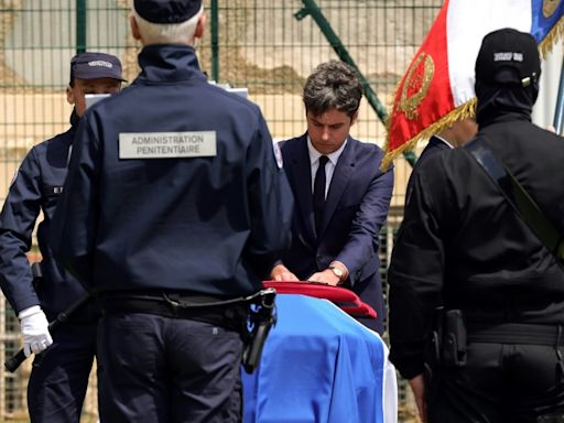 France pays tribute to prison officers, attackers still at large