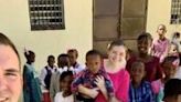 US missionaries Davy and Natalie Lloyd who were killed in Haiti on May 23, 2024, pose with Haitian children in an undated photo