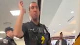 Officer threatens to arrest stranded airline passengers for trespassing in viral videos