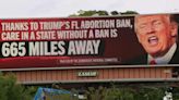 Billboards featuring angry-looking Trump appear day before controversial abortion law takes effect