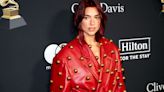 Dua Lipa Wears Eye-Catching Red Leather Trench Coat Covered With Gold Baubles