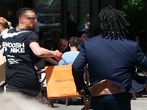 Brazen 'shoplifter' holding Louis Vuitton bags is chased by security