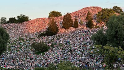 Watch: Thousands of Taylor Swift fans get free seats by perching on grassy hill