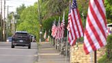 Volunteers hang flags in Westmoreland County to honor fallen police chief Justin McIntire
