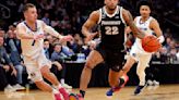 ...Devin Carter controls the ball as Creighton's Steven Ashworth defends in the first half during the quarterfinals of the Big East Tournament at Madison Square...