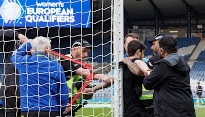 Protester chains himself to goalpost at behind-closed-doors match between Scotland and Israel
