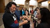 Ilya Tarshansky speaks Thursday with Carmit Novitzky, right, and Dror Kohler, center, about his experience in the Oct. 7th Hamas attack in Israel after his presentation at the...