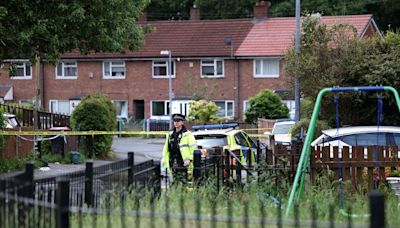 Crime scene in place on street after gun shots are blasted at house