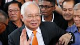 Malaysia halves prison term for ex-Prime Minister who oversaw multibillion-dollar 1MDB thefts