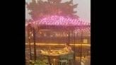 China: Woman Enjoys Hot Pot In The Midst Of Torrential Rainstorm In Chongqing