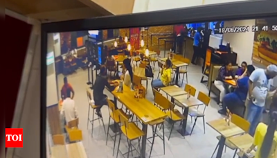 40 rounds of fire, chase, unfazed woman: CCTV shows chilling murder inside Burger King in Delhi | India News - Times of India