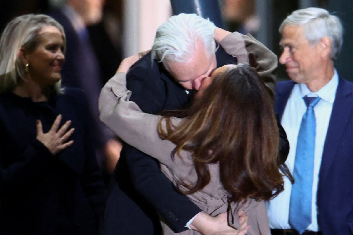 Julian Assange hugs and kisses wife as he arrives in Australia to cheering crowds