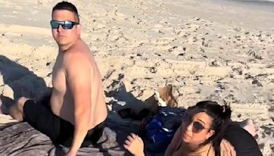Furious moment pregnant woman catches husband with mistress on beach