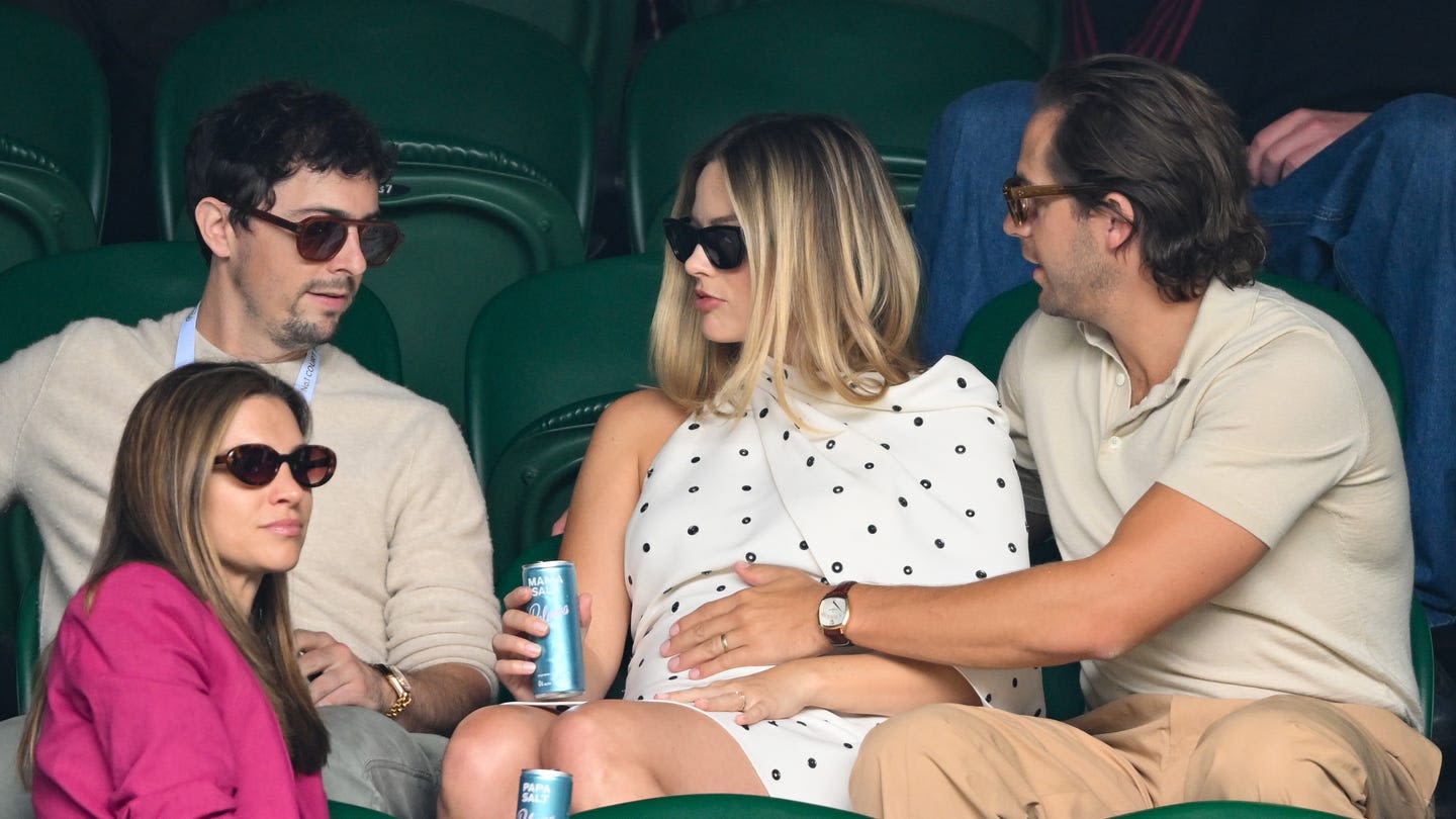 The Way Margot Robbie's Husband Touches Her Baby Bump Is A Sign Of 'Protection'