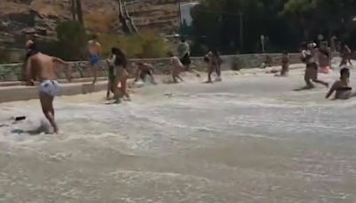 Watch as freak wave smashes beach in Mykonos leaving swimmer with broken ribs