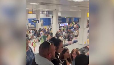 Large crowds at Manchester airport baggage claim after major power cut