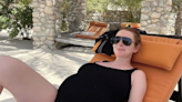 Lindsay Lohan shows off her baby bump in new swimsuit picture