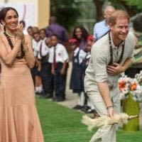 Britain's Prince Harry and his wife Meghan vist a school in Abuja to open an event on mental health for students