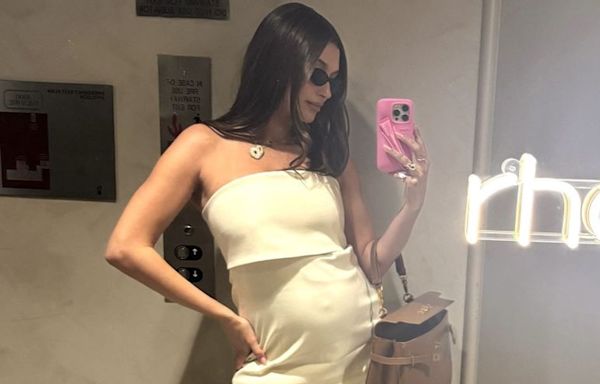 Pregnant Hailey Bieber Shows Off Baby Bump in Chic Cream Look as She Snaps Mirror Selfie: 'Working Hard'