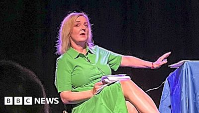 Liz Truss leaves stage in Beccles as 'lettuce' banner unfurls