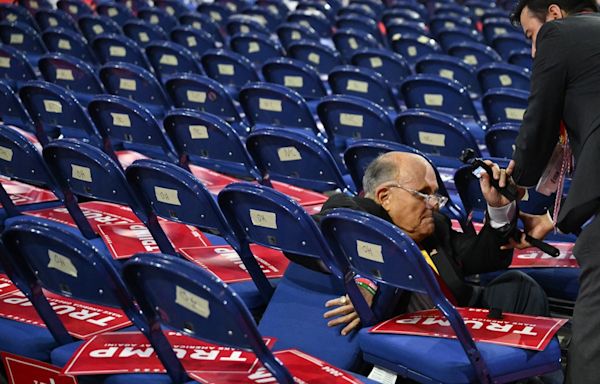 Rudy Giuliani takes a fall and tumbles into chairs while walking RNC floor