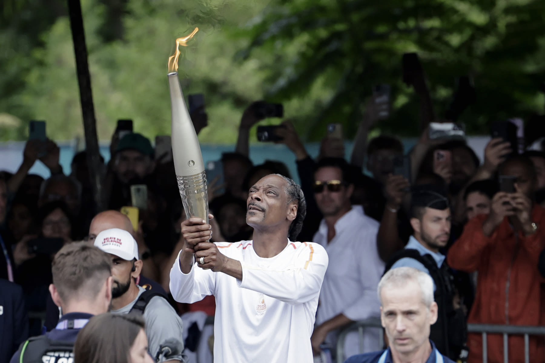 See Snoop Dogg Serve as Torch Bearer Ahead of Paris Olympics