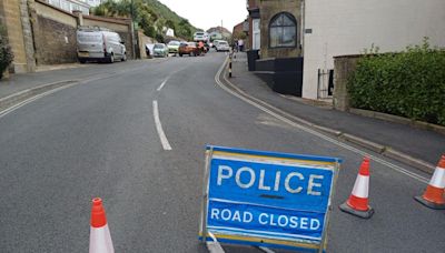 Road closed after crash into parked cars