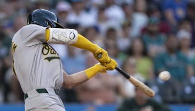 A's pull away late to pound Mariners