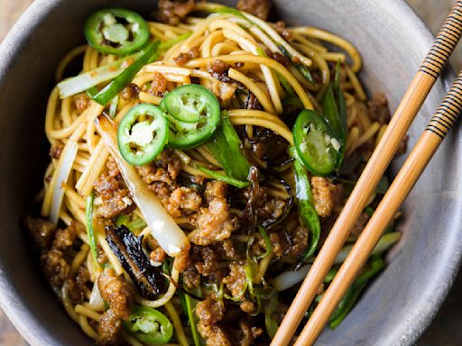 Thinly sliced fried scallions add bold flavor to savory pork noodles