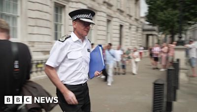 Moment Met Police's Sir Mark Rowley appears to push past journalist's microphone