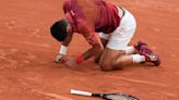 Novak Djokovic's French Open title defense and stay at No. 1 end because of an injured knee