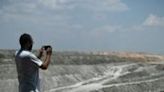 Indian environmental activist Alok Shukla takes photos of a coal mine in India's Chhattisgarh state