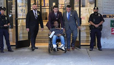 Wheelchair-bound man exits police station after 'dragging dead woman'