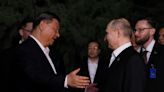 Hugs but not the full socialist-era kiss for Putin, Xi in Beijing