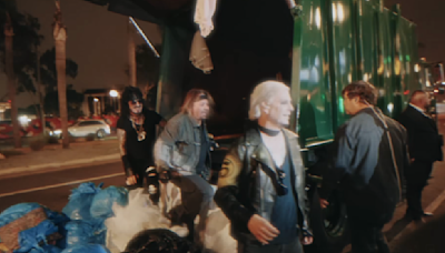 Watch Motley Crue get dumped out the back of a garbage truck on the Sunset Strip as they arrive for intimate Troubadour show