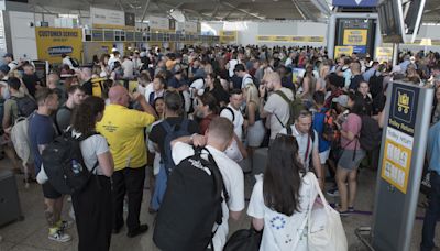 Airport staff forced to use WHITEBOARDS to show flight times during outage chaos