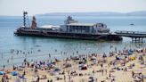 Thousands soak up sun on sand as temperatures rise