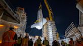 Space shuttle Endeavour is lifted into the sky, takes final position as star of new museum wing